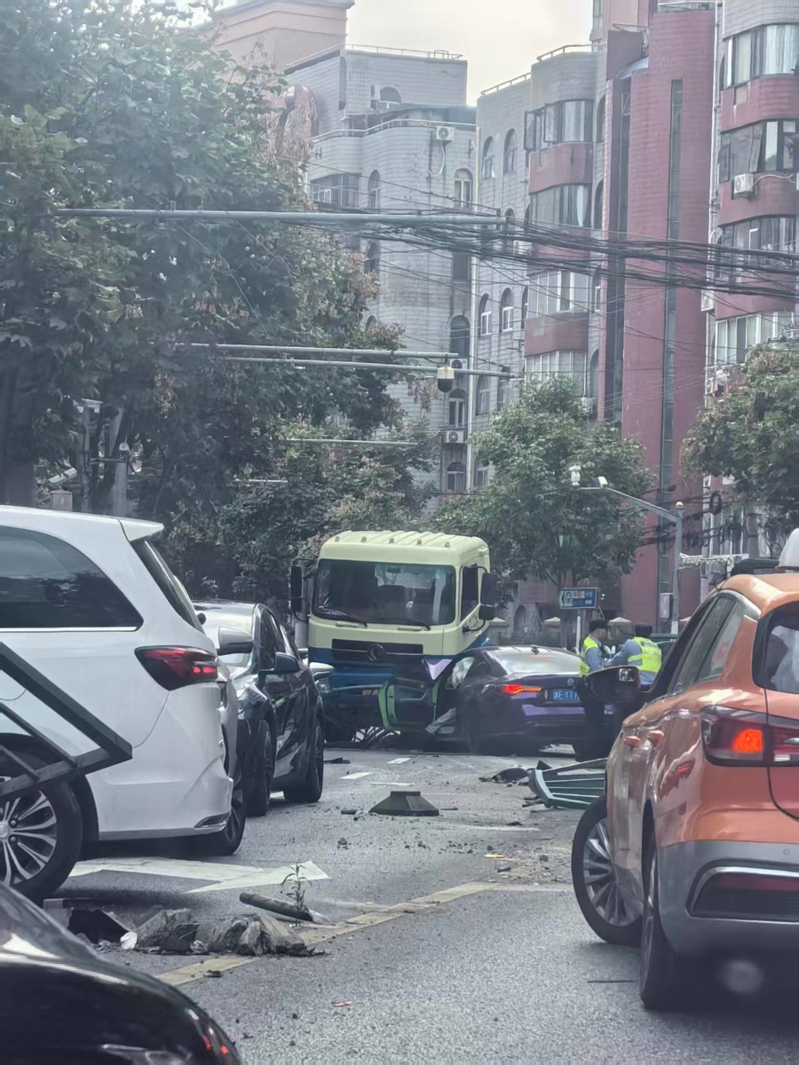 轿车冲破护栏撞上环卫卡车，驾驶员被警方现场控制